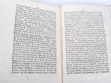 an open book on a table with a white background