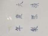 a plate with chinese writing on it on a table