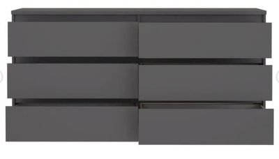 a close up of a dresser with four drawers on it