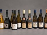 bottles of wine are lined up in a row on a table