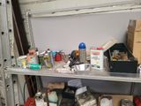 a metal shelf filled with assorted items in a garage