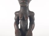 an image of a statue of a woman sitting on top of a wooden base