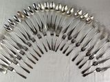 a lot of forks and spoons arranged in a circle