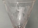 a glass vase with a picture of a woman on it