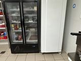 two refrigerators that are in a kitchen next to each other