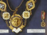 a gold necklace with a lion head on it