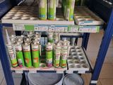 many cans of paint sitting on a shelf in a store