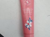a tube of hand cream sitting on top of a white table