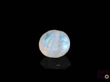 an image of a white moons stone on a black surface
