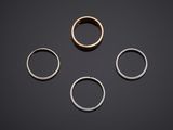 three different types of rings on a black surface