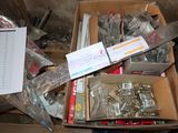 a box full of screws and nuts on the floor