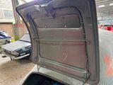 an open door of a car that is parked in a garage