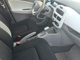 the interior of a car with black and white seats and a steering wheel