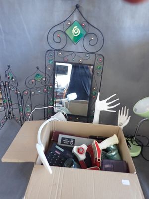 a cardboard box filled with assorted items and a mirror