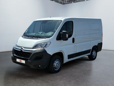 the white van is parked in a large white room