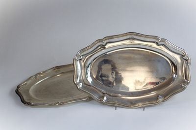 a silver tray with a silver lid on a white surface