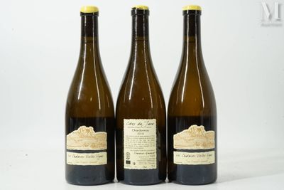 three bottles of wine sitting next to each other on a white surface