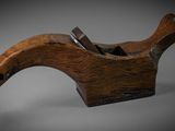 an old planer with a wooden handle sitting on a table