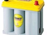 a close up of a yellow and blue car battery on a white background
