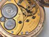 a close up of a pocket watch on a table
