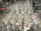 bottles and glasses on a glass table in a glass case