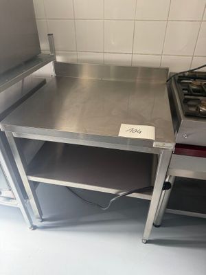 a stainless steel table with a stove in the middle of it