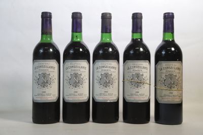 quatre bouteilles de vin sont alignées sur une table