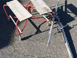 a broken picnic table on the ground in the parking lot