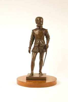 bronze statue of a man in a suit with a cane