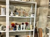 a shelf with a lot of dishes and glasses on it