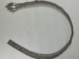a silver bracelet with a snake on it