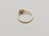 a close up of a gold ring on a white surface