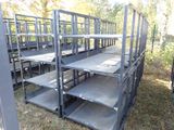 a lot of empty metal shelves in the middle of a field
