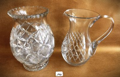 two glass pitchers sitting next to each other on a table