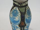 a blue and white vase sitting on a white surface