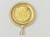 an image of a gold coin with a tassel hanging from it ' s side