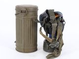 a toy soldier with a gas mask and helmet next to a trash can