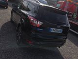 a black car that is parked in a parking lot