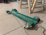 a green dolly that is sitting on the floor