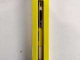 yellow box with a black pen inside of it on a white surface