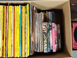 a box full of records and a record player