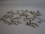 silver dog figurines are arranged in a circle on a white surface