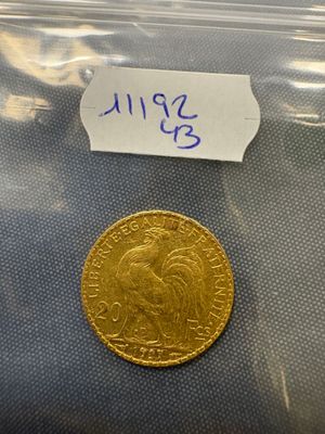 a close up of a gold coin in a plastic bag