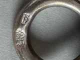 a close up of a silver ring with writing on it