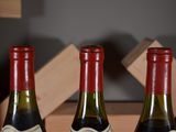 three bottles of wine that are sitting on a table