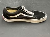 vans old skooler black and white sneakers on a gray surface