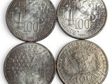 four different types of coins are shown on a white surface