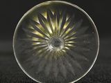 a close up of a glass object on a black surface