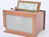 a small wooden box with a mirror in it