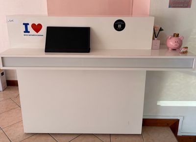 un bureau blanc sur lequel est posé un ordinateur portable